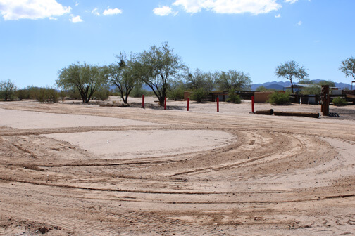 Spacious guest parking lot at Cocoraque Ranch with desert views